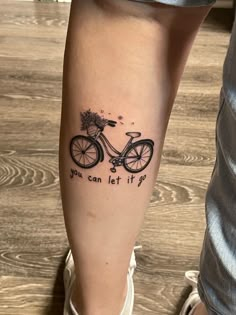 a person with a tattoo on their leg that says, you can let it go