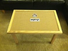 a coffee table with an orange label on it sitting in front of a black couch