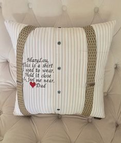 a pillow with a message on it sitting on a couch