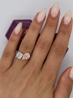 a close up of a person's hand with a ring on it and some nails