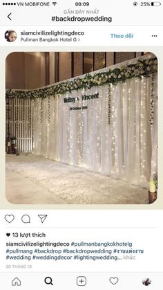 an image of a wedding stage decorated with white lights and greenery on the side