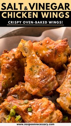 some chicken wings are in a basket with the words salt and vinegar chicken wings crispy oven - baked wings