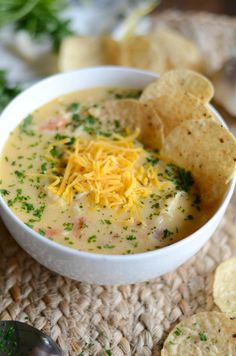 a bowl of soup with cheese and crackers