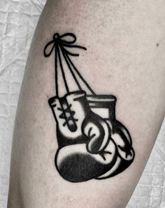 a black and white tattoo of a boxing glove