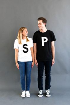 a man and woman standing next to each other with the letter p on their t - shirts