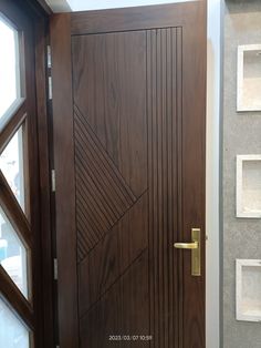 a wooden door with a metal handle on the front and side doors to both sides