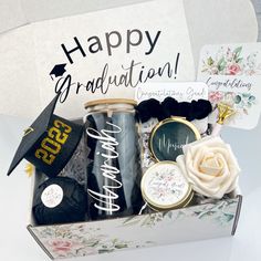 a graduation gift box filled with congratulations items