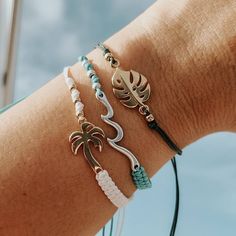 Adjustable Colorful Beach Bracelets with a cute Charm for that summer look. Super Dainty and great for stacking or creating that unique surfer girl beach look.. Perfect as a gift to yourself or for that special beach person in your life! Pair it with our unique shark bracelets! Choose: ♡ Nylon Bronze with Silver Wave - Lead and Nickle Free ♡ Nylon Teal with Silver Wave - Lead and Nickle Free ♡ Nylon White with Gold Palm Tree - 24K plated ♡ Nylon Green with Gold Monstera Leaf - 24K plated ♡ Closu Summer White Adjustable Friendship Bracelets, White Adjustable Cord Friendship Bracelets For Beach, Adjustable Braided Bracelets For Beach Vacation, Adjustable Friendship Bracelets For Beach Vacation, Adjustable Friendship Bracelets For Beach Season Vacation, White Adjustable Friendship Bracelets For Beach, Summer White Bracelets With Adjustable Length, Summer Beach Resizable Braided Bracelets, Adjustable Beachy Braided Bracelets For Vacation