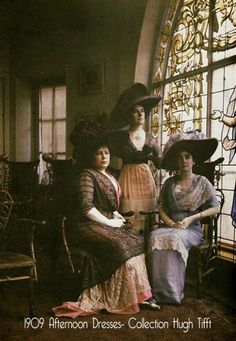 three women sitting next to each other in front of a stained glass window with the sun shining through