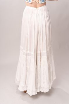 Stunning Edwardian 1910’s white cotton and lace maxi petticoat skirt. With a pretty flare silhouette, panel lace detail, and a button closure at waist. Good vintage condition, with normal wear and condition for its age. Some areas of visible mending a minor staining - see pictures. Best fits modern size XS/S Waist 26”Length 42” Featured top is the Blue Doll Quilt Corset from our friends at Psychic Outlaw. Model’s Measurements:Height 5’9”Chest 34”Waist 29”Hips 36.5” Daywear Long Lace Skirt, Vintage White Gathered Skirt Bottoms, White Lace Vintage Bottoms, Vintage White Lace Bottoms, White Vintage Lace Bottoms, Lace Trim Maxi Skirt For Wedding, Flowy Wedding Maxi Skirt With Lace Trim, Bohemian Bottoms With Lace Trim For Daywear, White Bohemian Maxi Skirt For Daywear