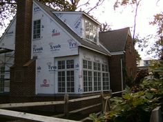 a house is being built with the roof up and windows still in place on it