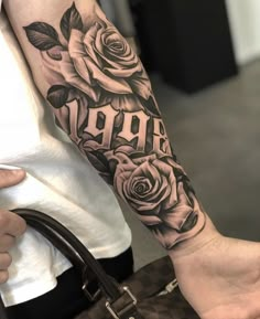 a woman's arm with roses and the word aro tattooed on it