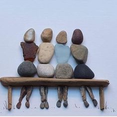 a group of rocks sitting on top of a wooden bench in front of a white wall