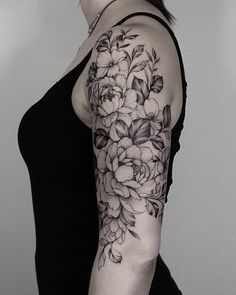 a woman with a black and white flower tattoo on her arm