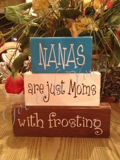 a wooden block that says namas are just moms with frosting