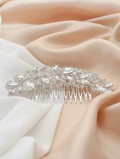 Looking for the perfect hair accessory to add a touch of sparkle and glamour to your wedding outfit? Our Oval Crystal Hair Clip is here to make you look absolutely stunning. Crafted from Swarovski jewels and finished with a floral motif, it is sure to make you the center of attention. With its design that drapes along the hairline, it provides a secure fit for any occasion. Get your show-stopping look with our Oval Crystal Hair Clip! Update your wardrobe with Oval Stones Crystal Hair Clip. It's Crystal Hair Clip, Wedding Clip-on Crystal Earrings With Sparkling Stones, Diamond Hair Clip, Elegant Crystal Clip-on Earrings With Sparkling Stones, Crystal Bridemaid Hair Clip, Crystal Hair Clips, Floral Hair Clip, Bridal Hair Clip, Wedding Hair Clips