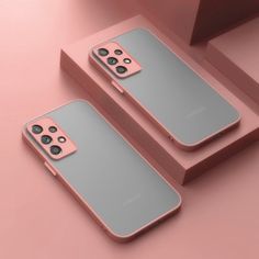 two pink and gray iphone cases sitting on top of each other