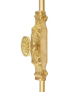 an ornate gold door handle on a white background