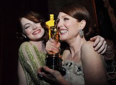 two women smile as they hold their oscars