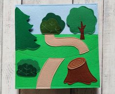 a handmade card with trees and a road