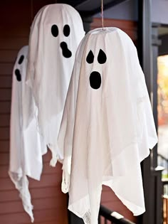 two ghost decorations hanging from the side of a house with text that reads, halloween door decorations great wreaths and entry accents