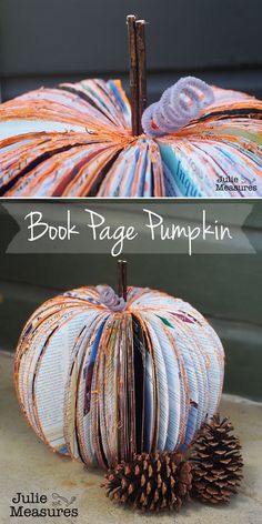 a book page pumpkin sitting on top of a pile of books next to a pine cone