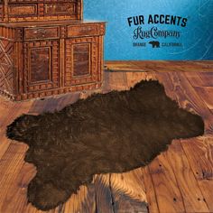 an animal skin is laying on the floor in front of a wooden cabinet and chest