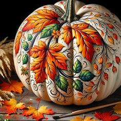 a painted pumpkin sitting on top of a wooden table