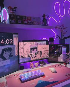 a desk with two computer monitors and a keyboard on it in front of purple lighting