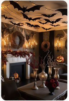 a living room decorated for halloween with candles and decorations hanging from the ceiling over fireplace