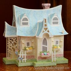 a small doll house on top of a wooden table