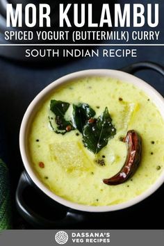 a bowl filled with soup and topped with green leaves