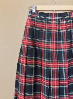 "Authentic vintage pleated plaid skirt. High waisted and longer in length. Waistband has elastic on each side for added comfort. Button and zipper closure in back. Skirt is in excellent, like new, clean condition with very little to no signs of previous wear. Measurements (taken zipped or buttoned up and laid comfortably flat) x2 inches Willow Ridge Tag Size 6P Made in USA Waist 25\"-27\" Hips 38\" Length 31\" All items are free of rips, tears, holes, and stains. Vintage items are subject to sig Fitted Plaid Pleated Tennis Skirt, Plaid Mini Skirt For School, Retro Pleated Mini Skirt For School, Preppy Plaid Mini Skirt For School, Plaid Skirted Skort For School, Retro High Waist Skirt For School, High Waist Plaid Pleated Skirt, Plaid Bottoms For School In Fall, Plaid Pleated Mini Skirt School Uniform