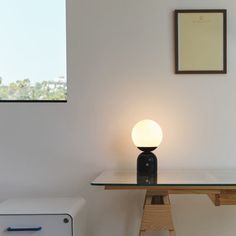 a table with a lamp on it in a room