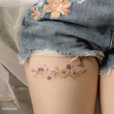 the back of a woman's thigh with flowers on it