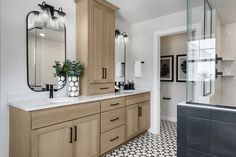 a bathroom with wooden cabinets and white tile flooring