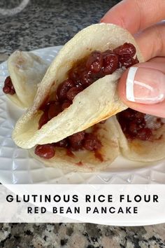 a hand is holding a piece of food on a plate with the words glutinoous rice flour red bean pancake