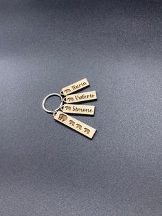 three brass key chains with the words,'la viezza del monte'on them