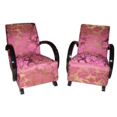 a pair of pink and gold chairs sitting next to each other