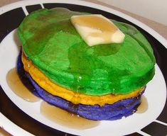 a green and yellow cake sitting on top of a white plate