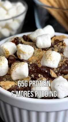 a bowl filled with s'mores pudding and marshmallows on top