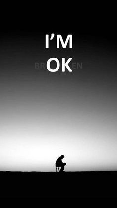 a man sitting on top of a hill with the words i'm ok