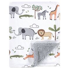 a blanket with animals on it and a grey thrower in the middle, next to a white background