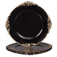 black and gold plates stacked on top of each other in front of a white background