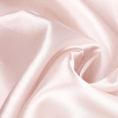 a close up view of a pink satin fabric