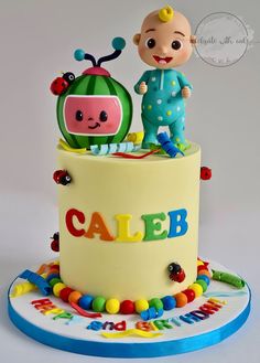 a cake decorated with a baby's name and an image of a child on top