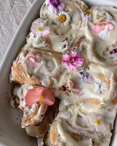 a white plate topped with pastry covered in icing and flowers