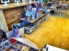 the inside of a store with many items on display and in front of it is a wooden counter