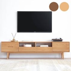 a flat screen tv mounted to the side of a wooden entertainment center in a living room