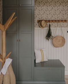 a wooden bench sitting next to a gray cabinet